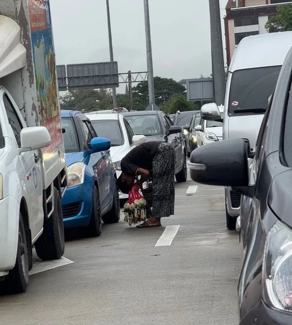 清迈_清迈街头卖花人 90度鞠躬 路途平安花环